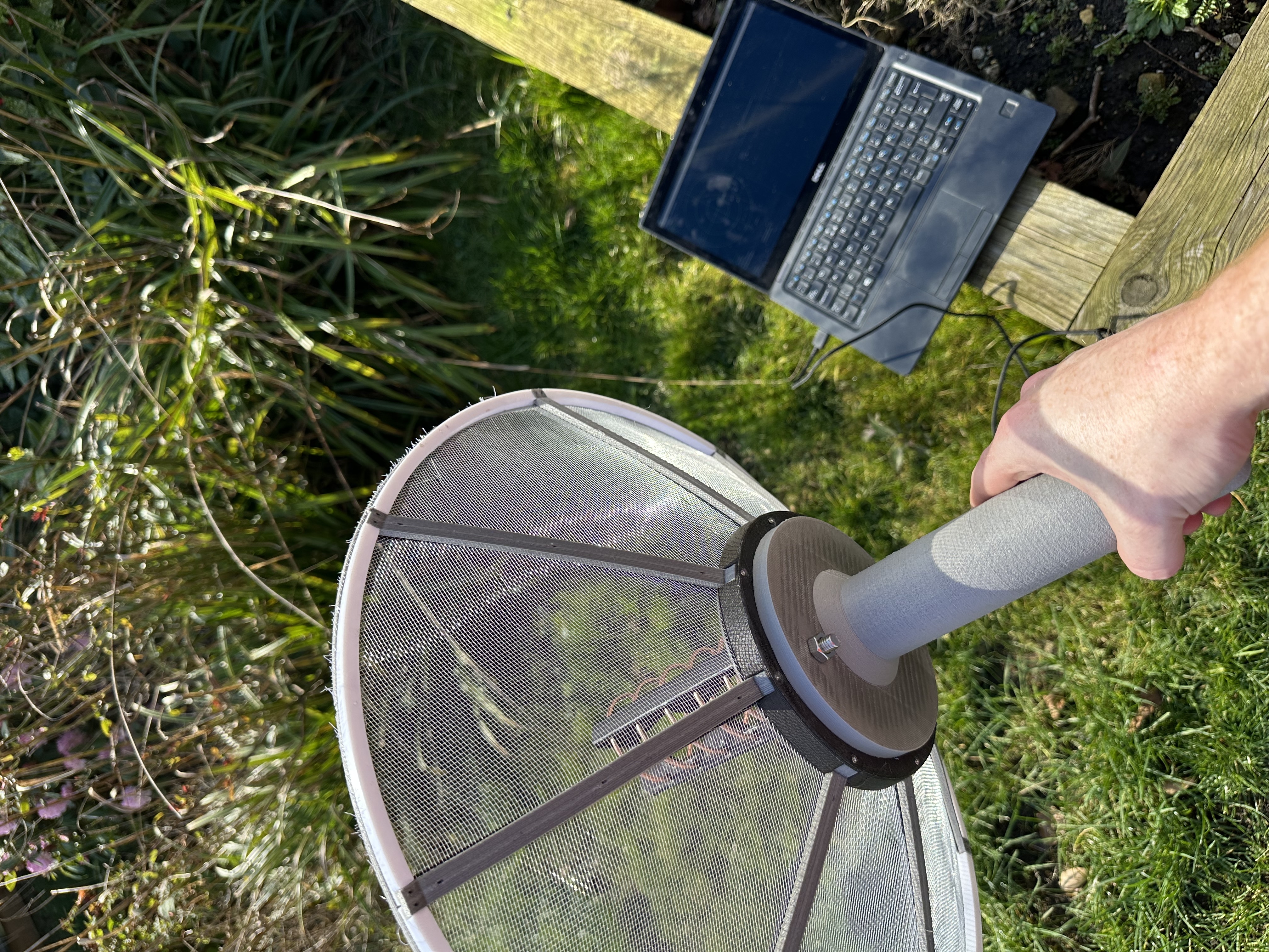 Me standing in the garden waving an antenna at the sky.